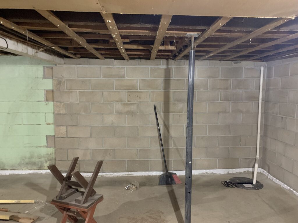 Rebuilt section of a block basement wall where new block meets the original wall