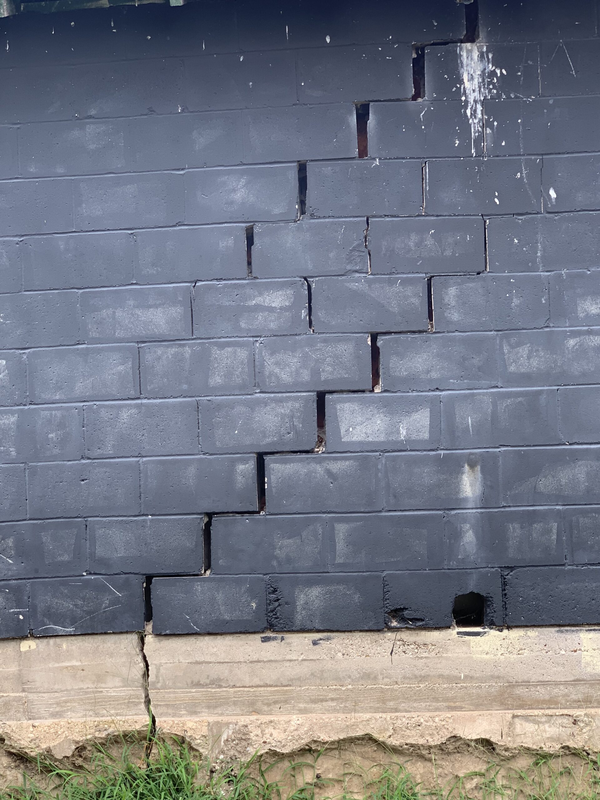 Stair-step cracking following the mortar joints of a block basement wall in the Quad Cities