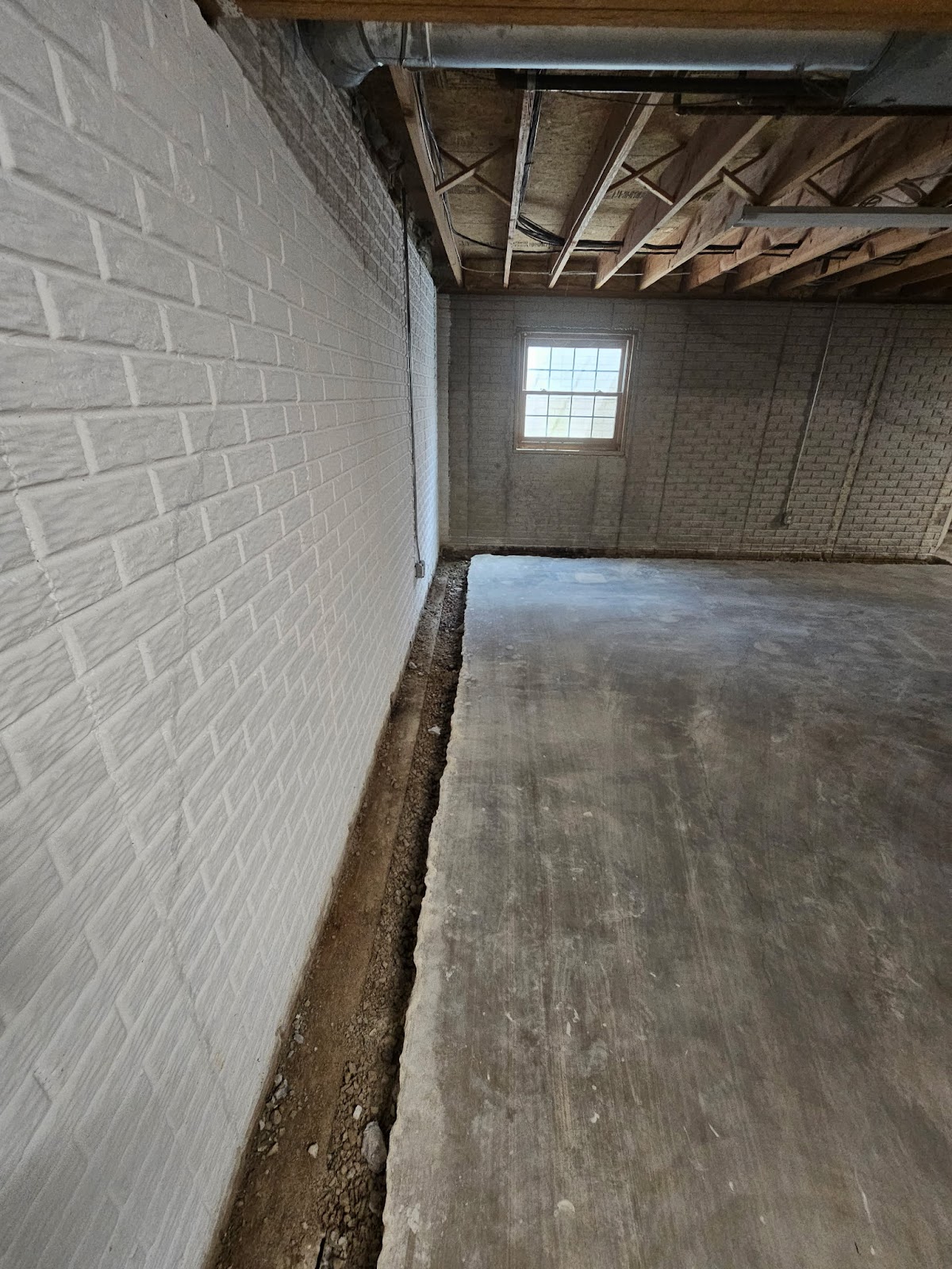 Basement waterproofing drain tile correction near Moline, IL — project photo 3