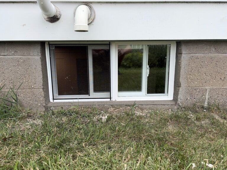 New slider basement window installed in a concrete block foundation in Davenport, Iowa