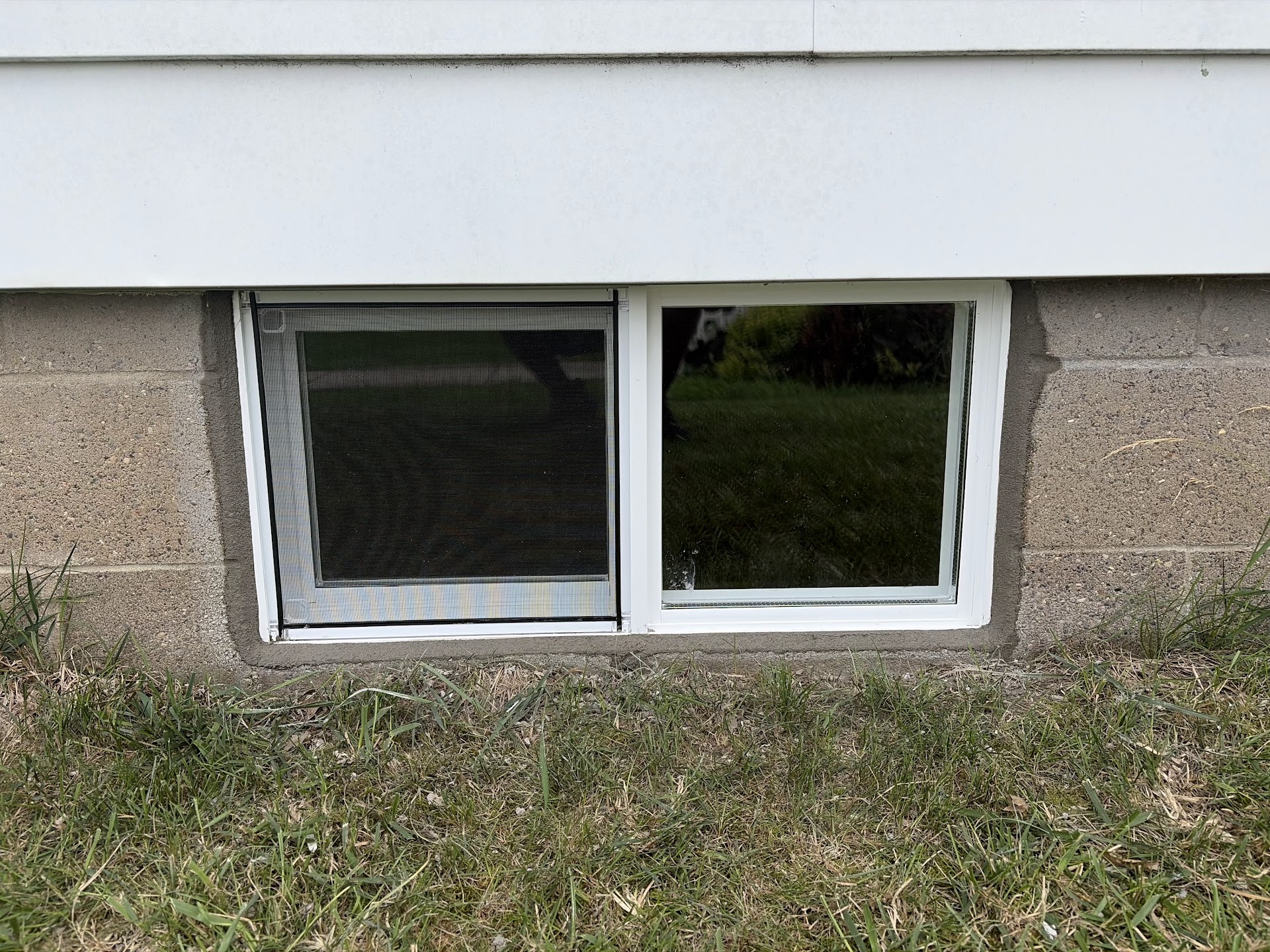 New basement window installed and sealed from the exterior