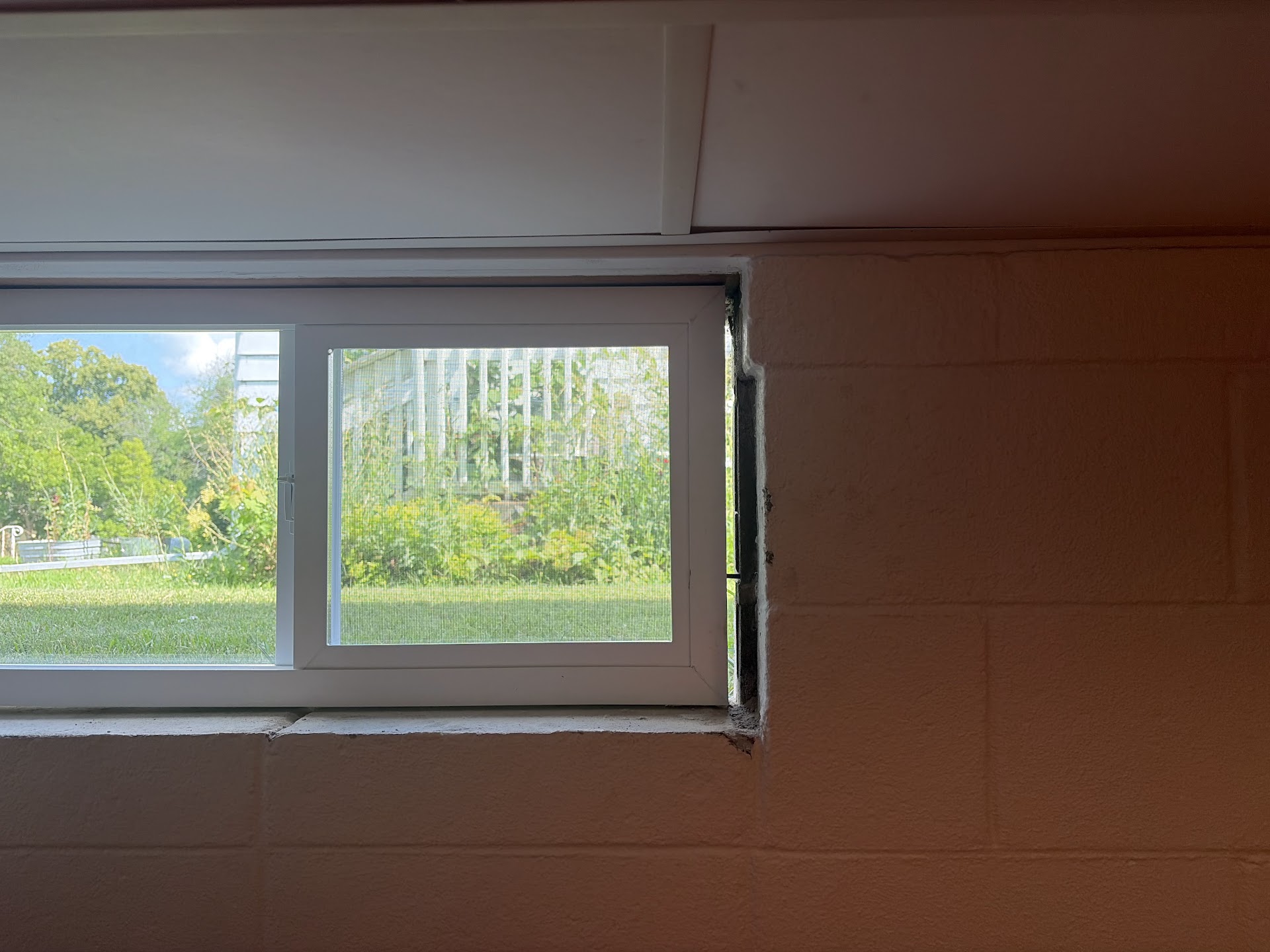 Interior view of a newly installed slider basement window