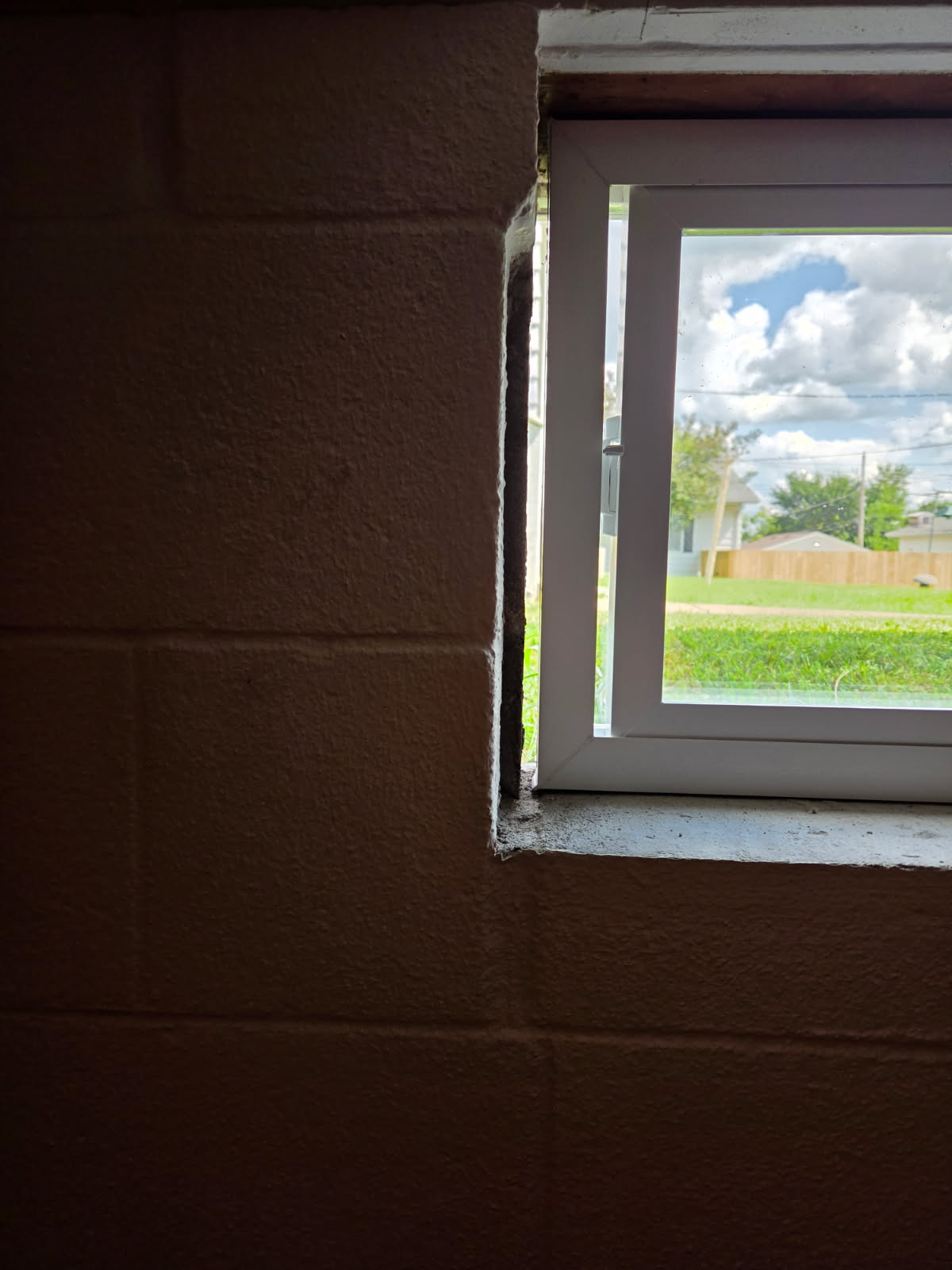 Replacement basement window set and sealed in the block foundation