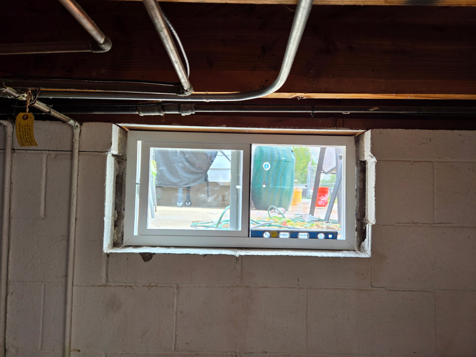Basement window opening prepared for a new slider unit