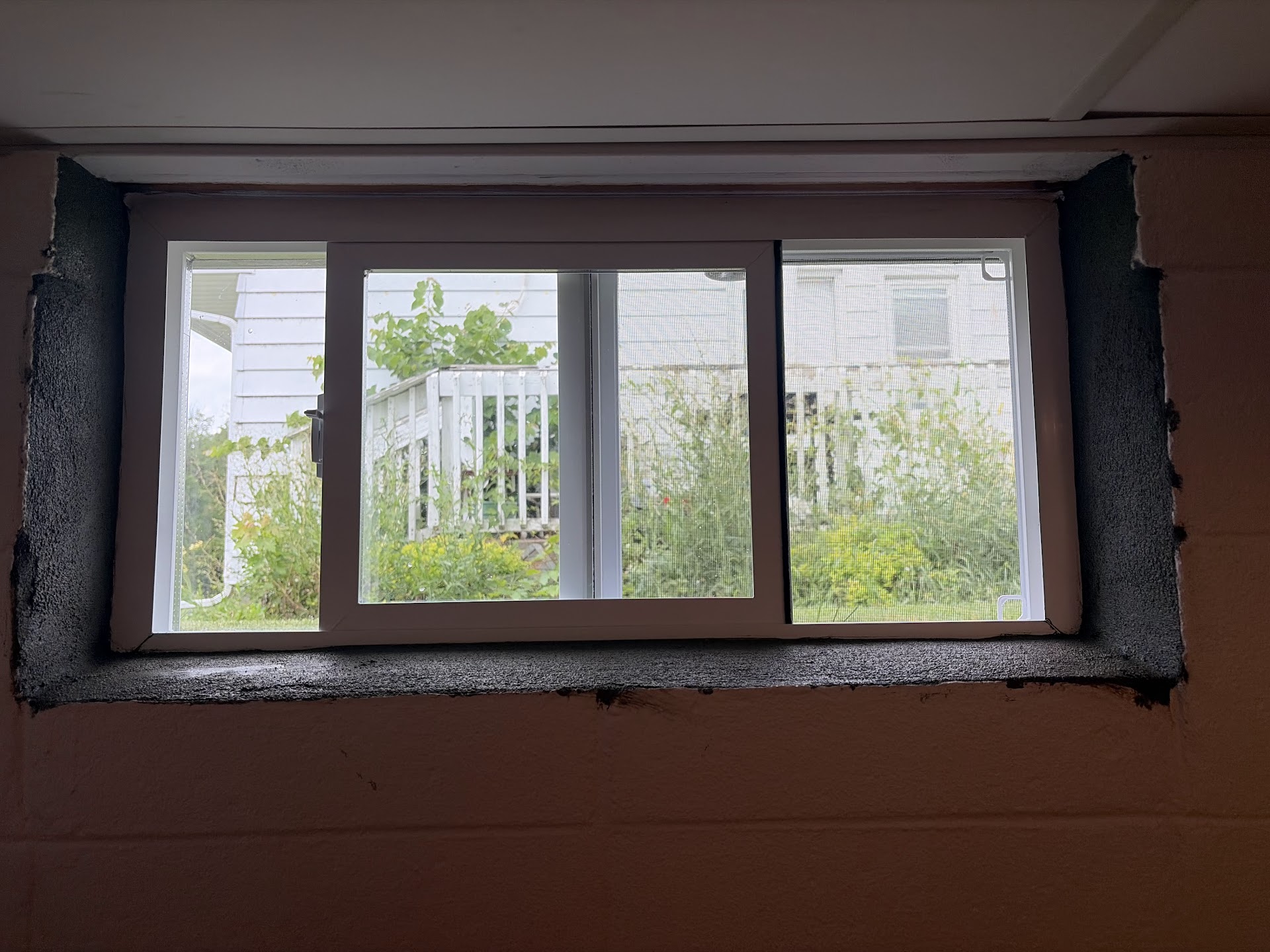 New slider window secured in the foundation wall