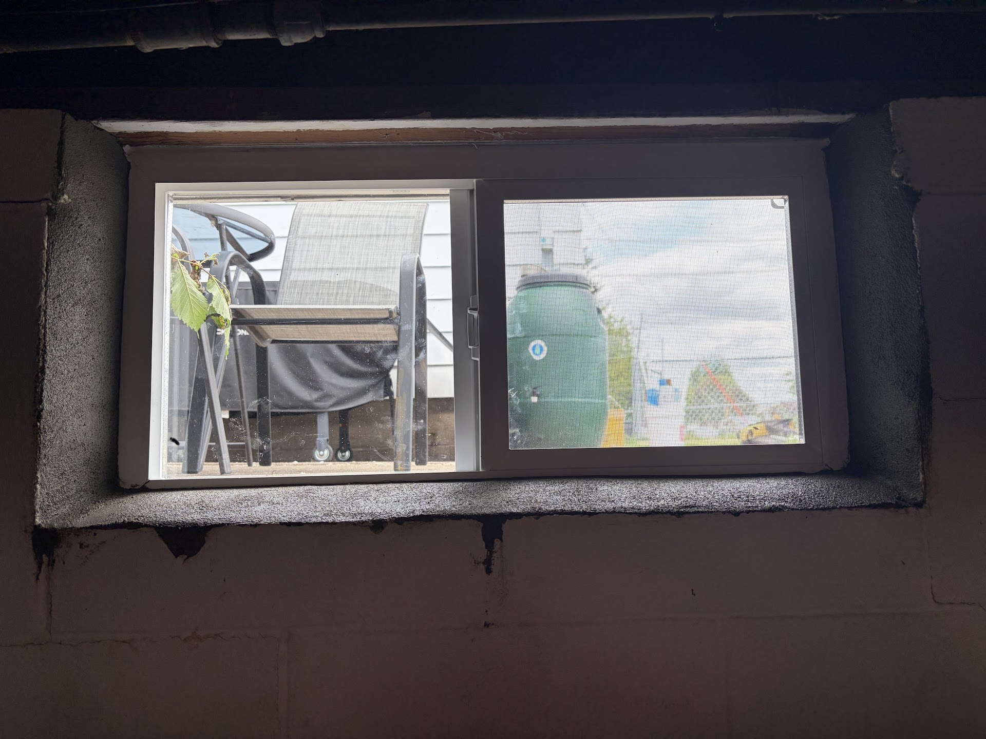 Exterior view of a replaced basement window