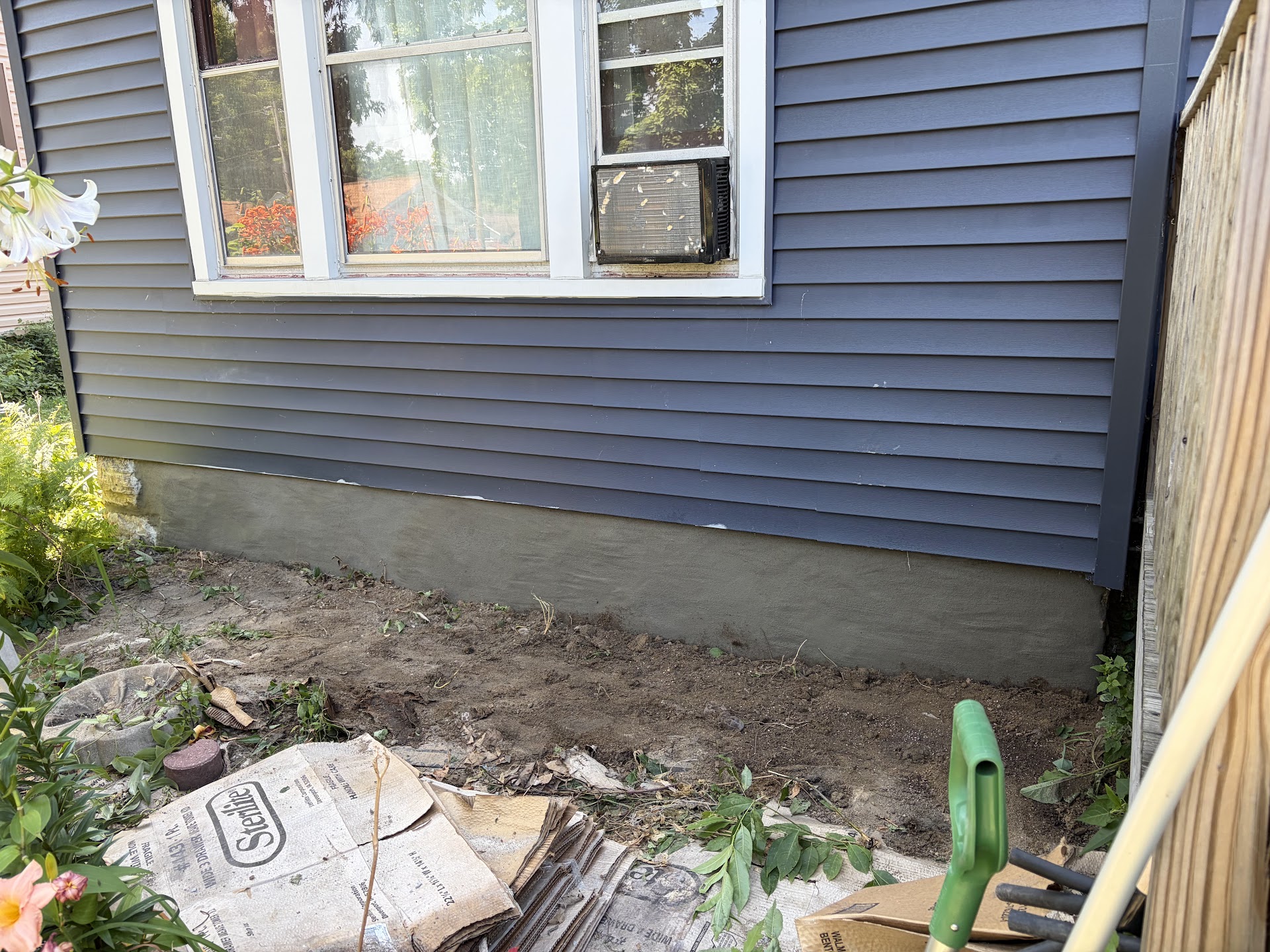 Completed exterior foundation with a new parge coat below the siding, Davenport IA — Behncke Construction