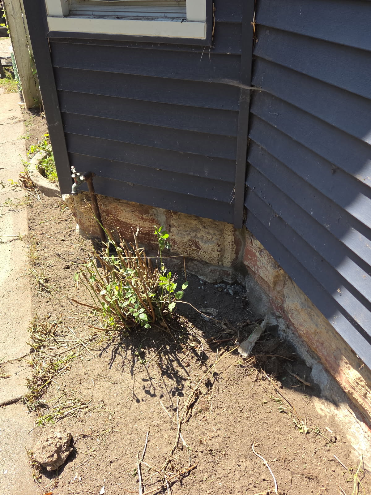 Exposed foundation corner and mortar before masonry repair, Davenport IA