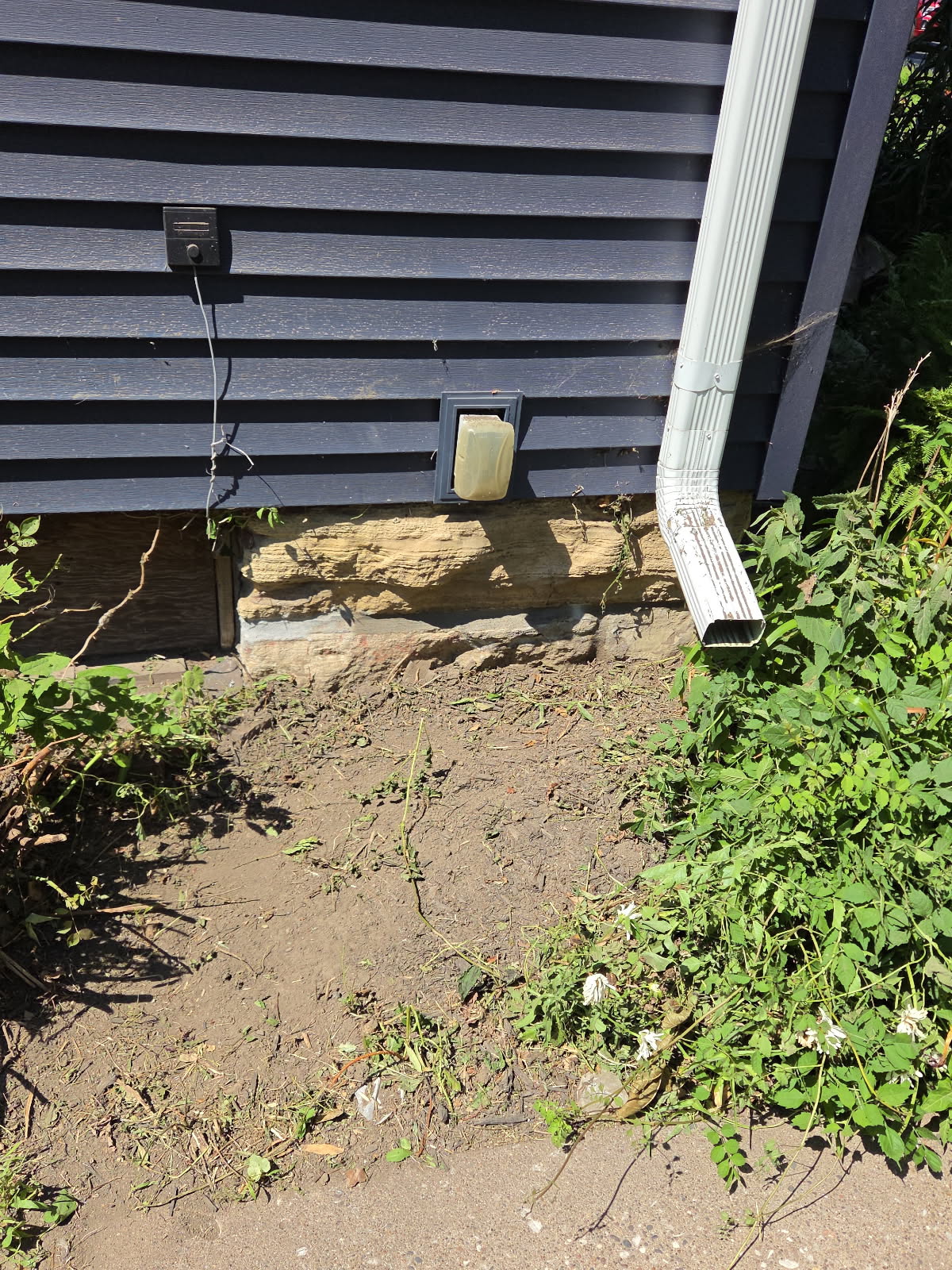 Foundation base near the downspout before repair, Davenport IA