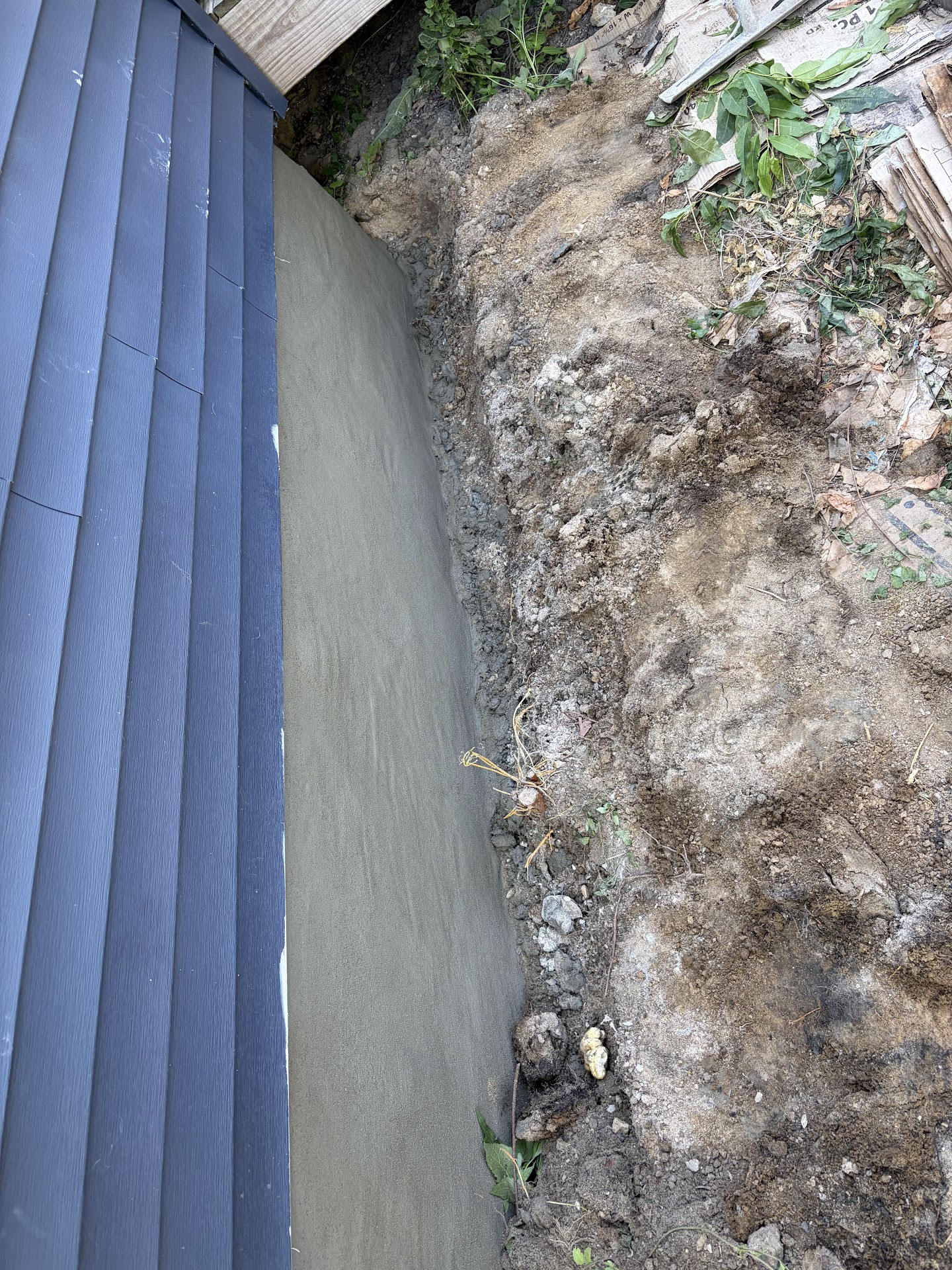 Fresh parge coat applied to a repaired foundation wall, Davenport IA — Behncke Construction