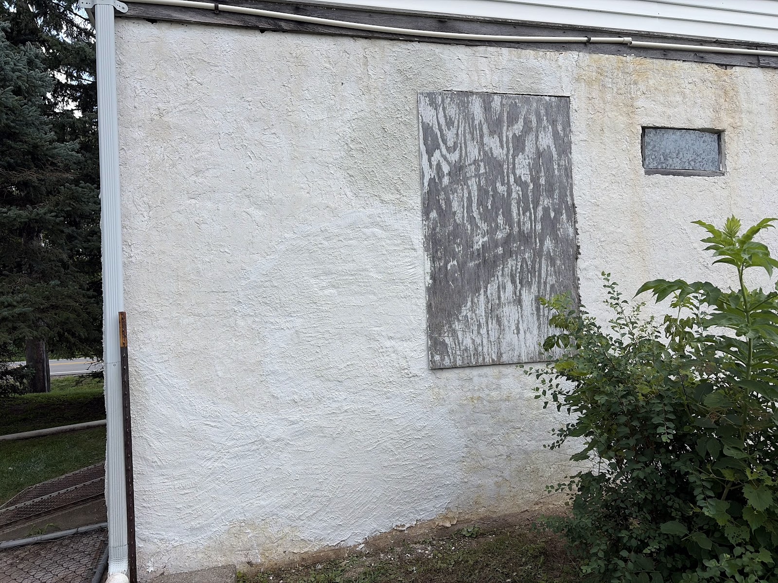 Completed exterior stucco repair on a Bettendorf, Iowa home — the restored wall now carries a uniform surface bonding cement finish that blends with the existing exterior