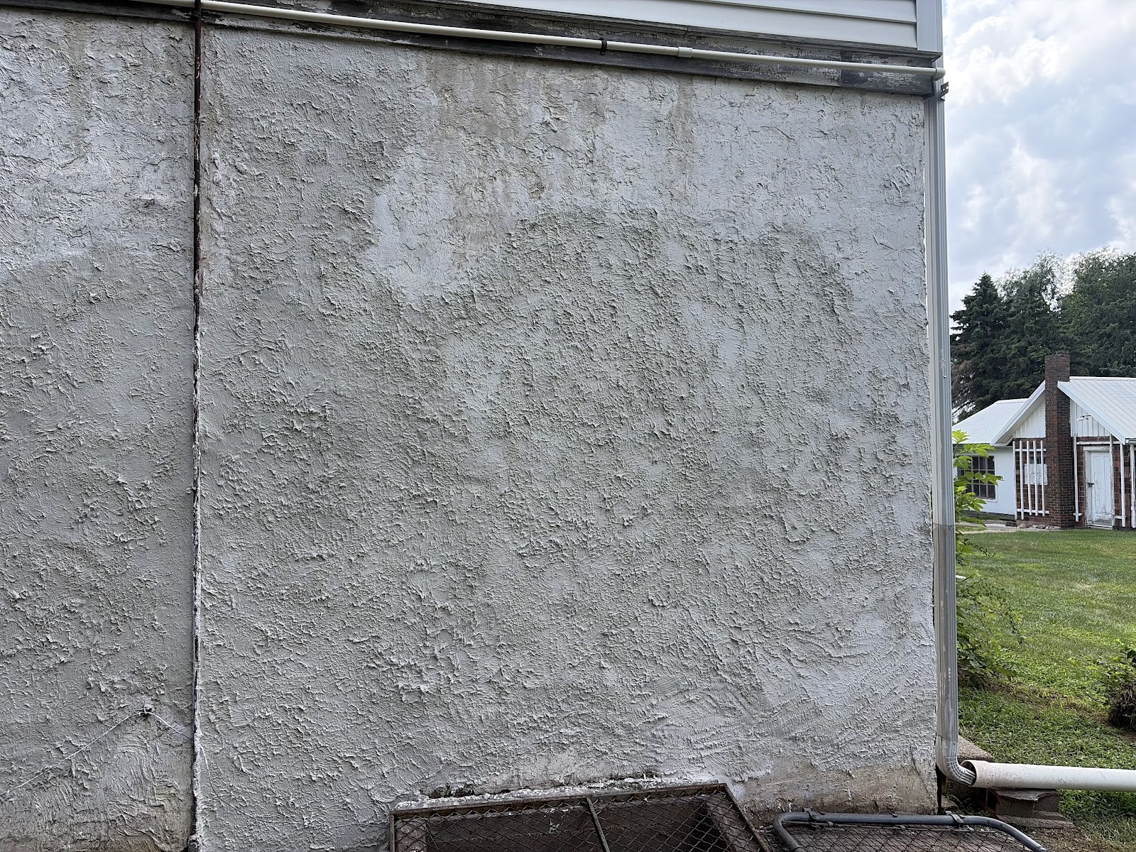 Freshly applied surface bonding cement forming a uniform coat across the prepared wall