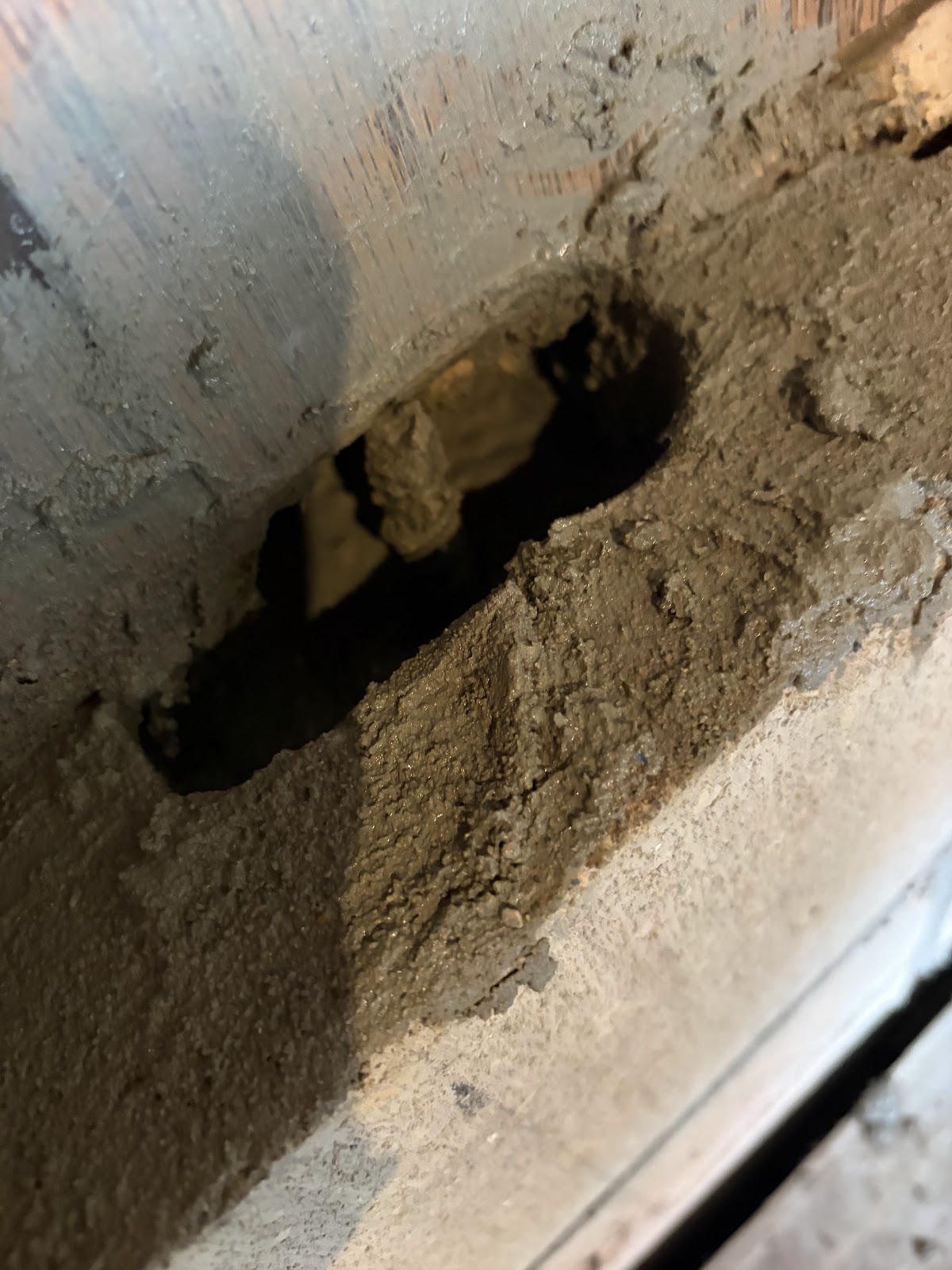 Open cavity in the concrete block wall before it was reinforced with rebar and mortar