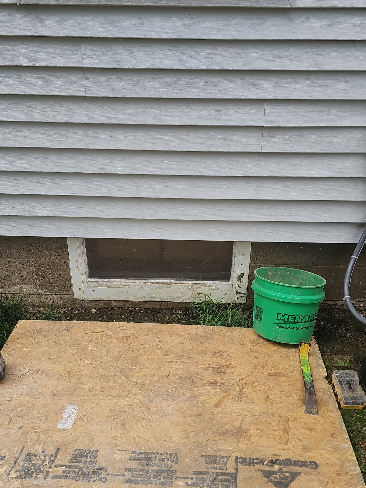 Old basement window opening after the aging window was removed, before the glass block was installed