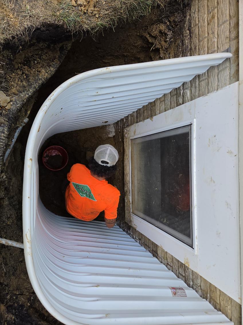 Excavating a leaking egress window well that had been installed too high