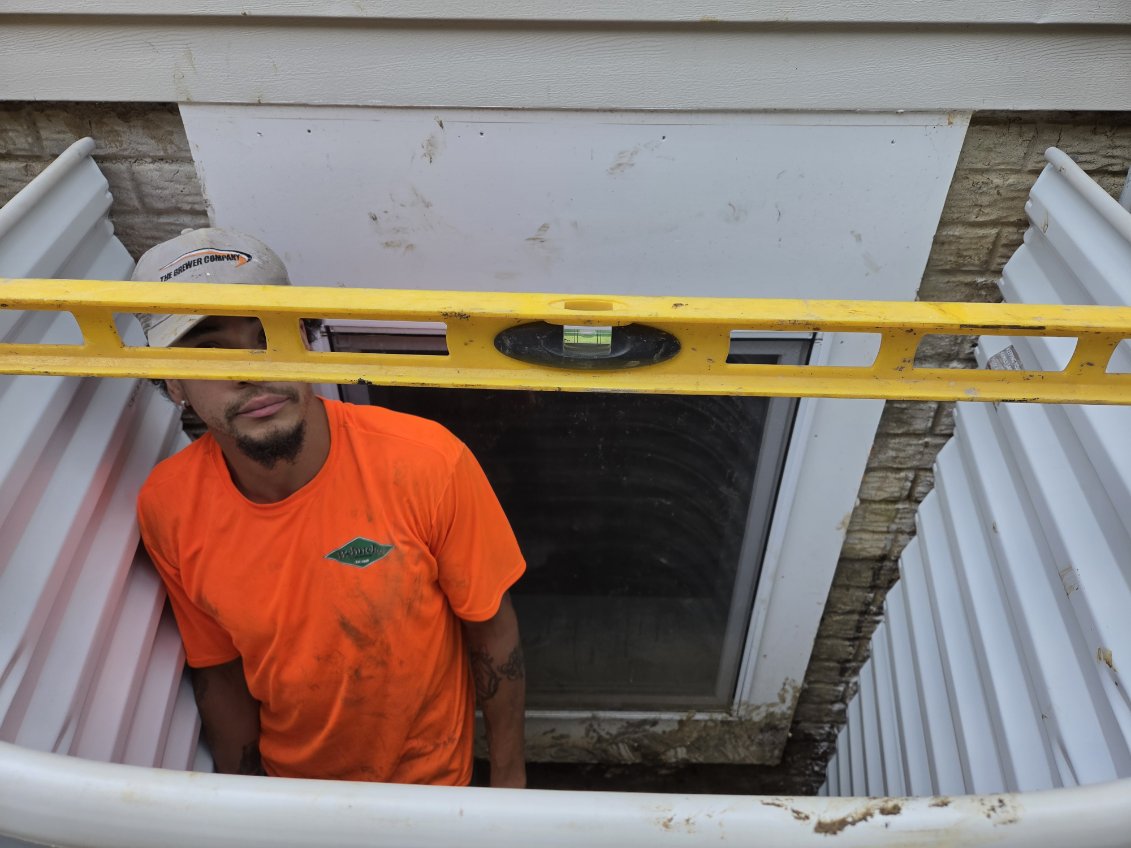 Checking the depth of the egress window well below the window sill