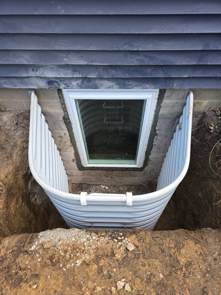 New larger code-compliant egress window well with a protective cover in Bettendorf, Iowa