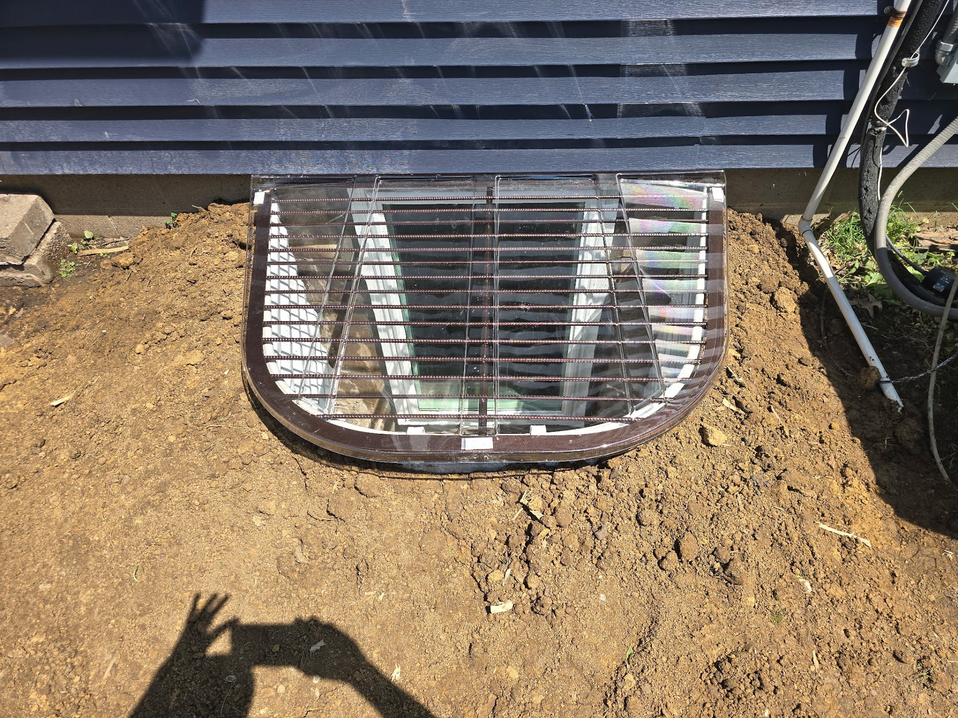 Removing the undersized original window well during excavation