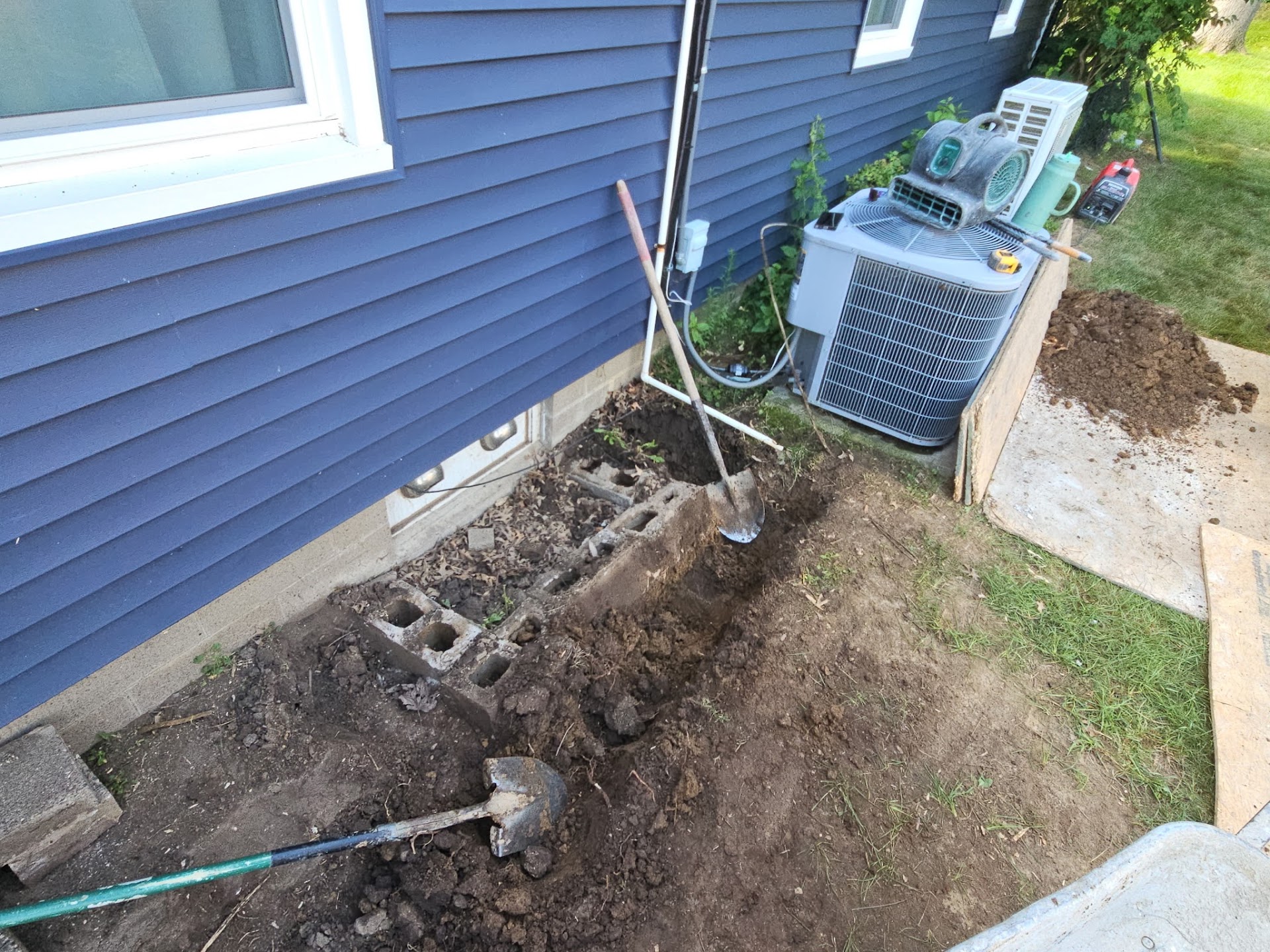 Setting the new, larger egress window well against the foundation