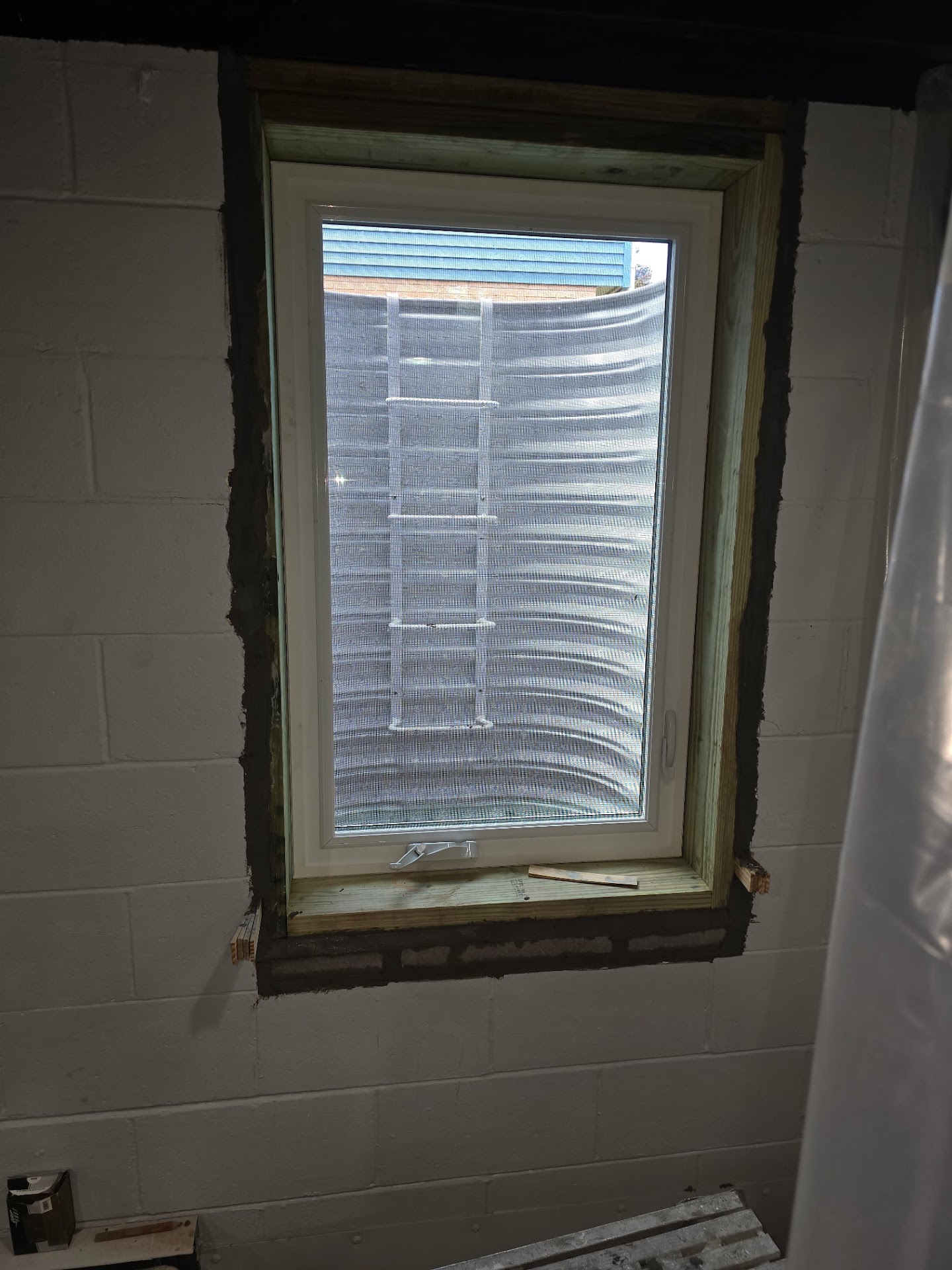 Interior view of the basement egress window served by the new well