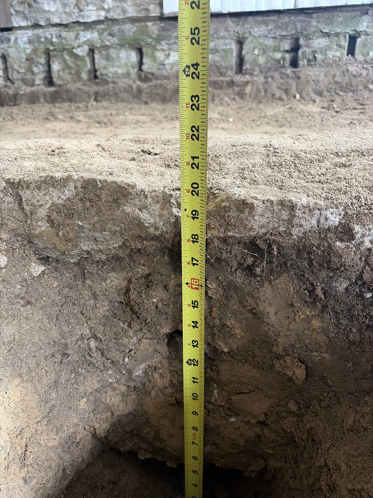 Crawlspace excavated and prepared before installing the new moisture barrier and floor framing