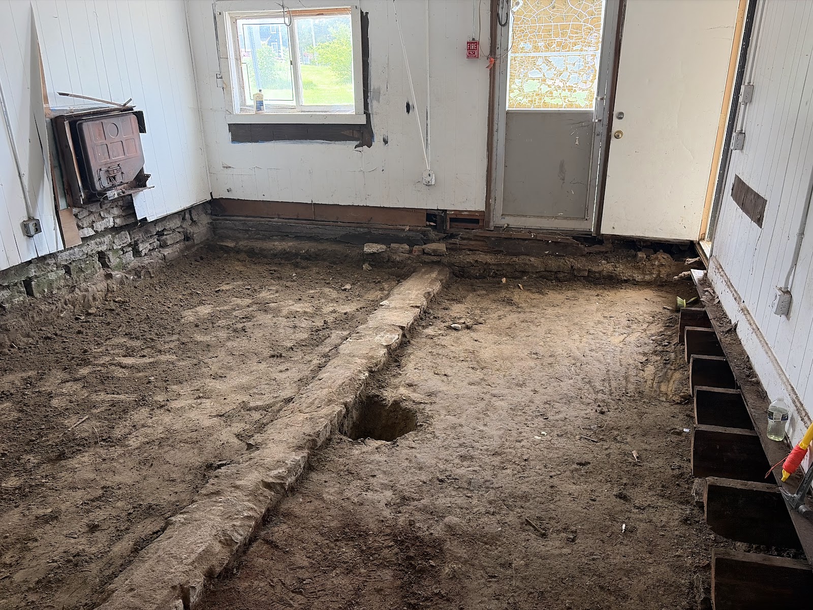 Deteriorated wood floor framing exposed before removal in a Davenport home