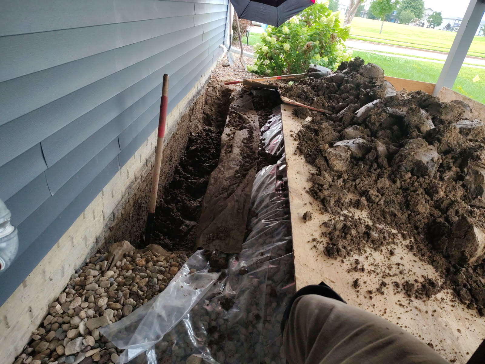 Hand-dug excavation trench alongside the foundation to reach the crack