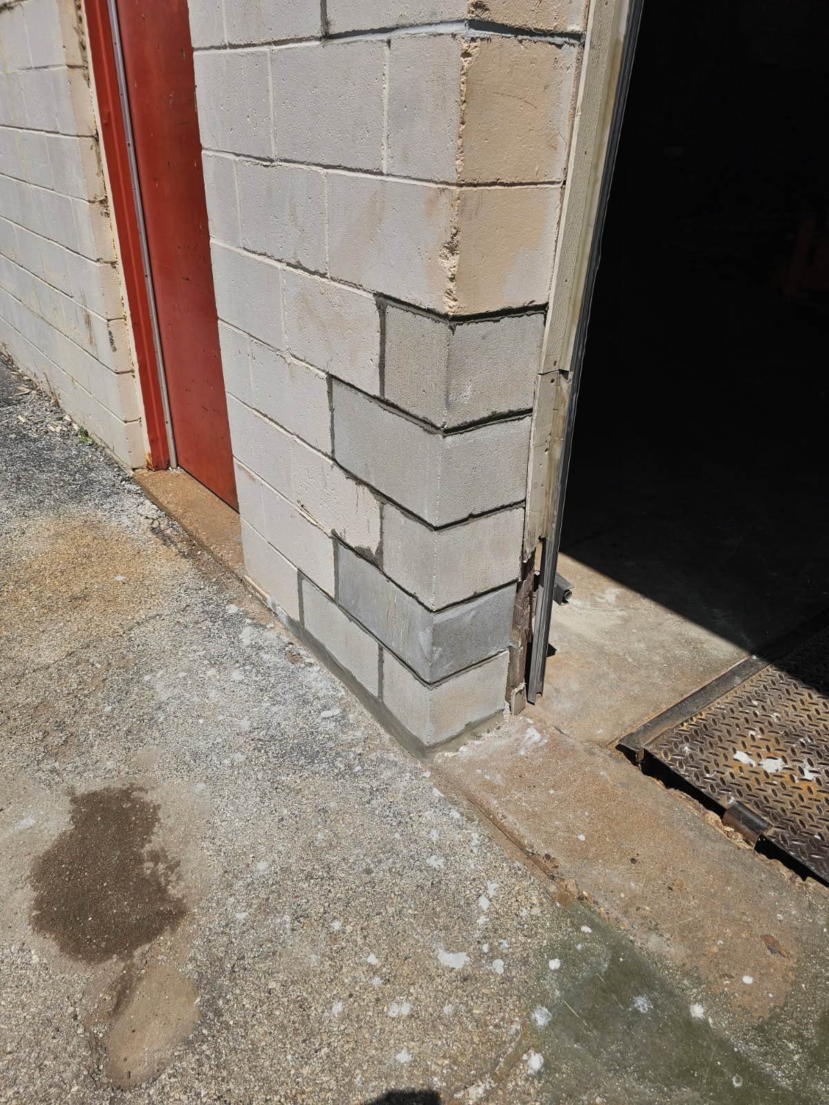 Repaired structural block wall corner with new CMU blocks — completed