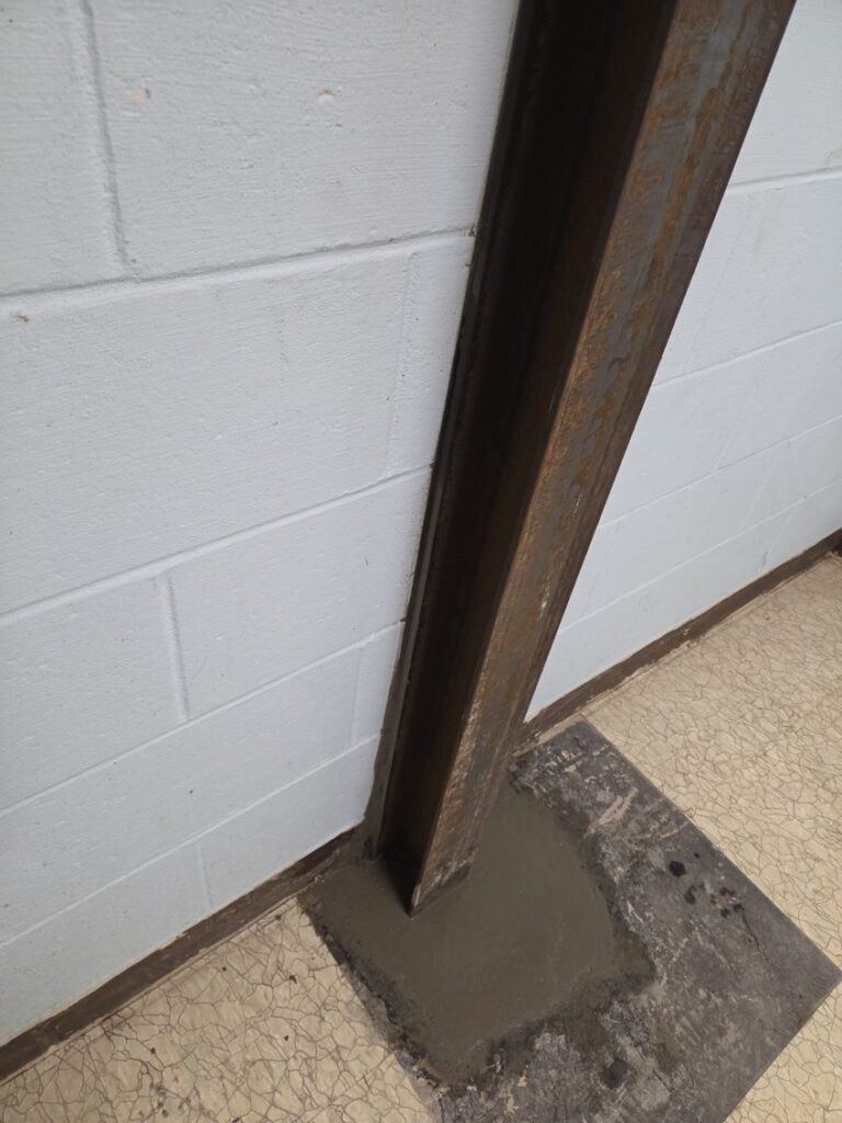 Steel I-beam braced tight against a stabilized basement wall in Bettendorf, Iowa