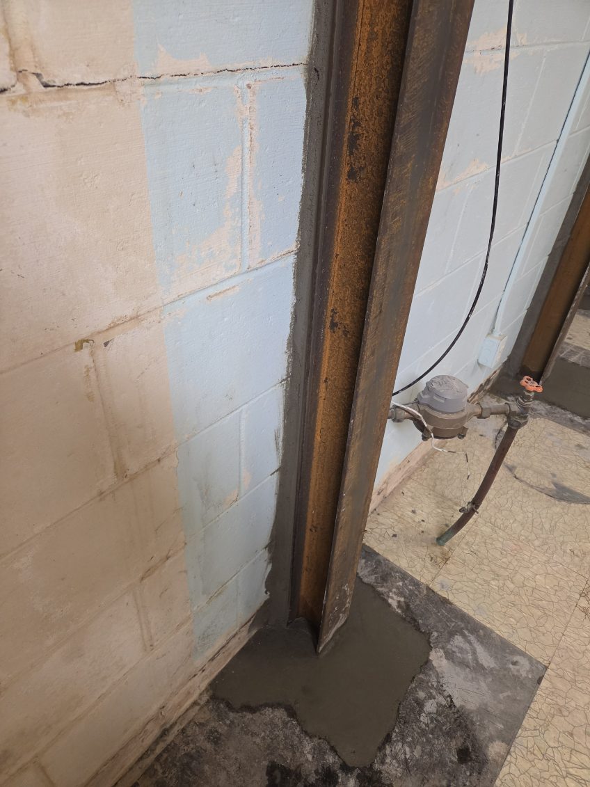Bowing basement wall with a vertical crack before final bracing in Bettendorf