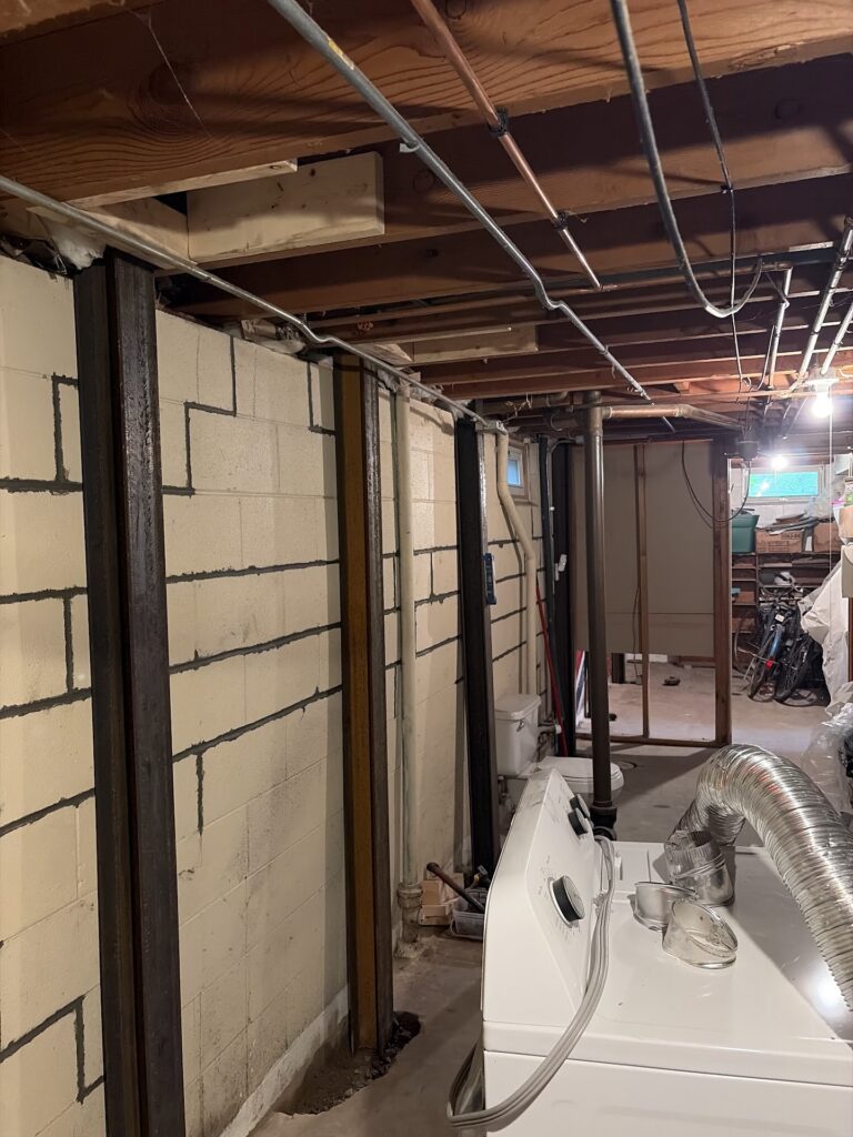 Foundation wall bracing, interior waterproofing and tuckpointing project in Davenport, IA — photo 15 of 19