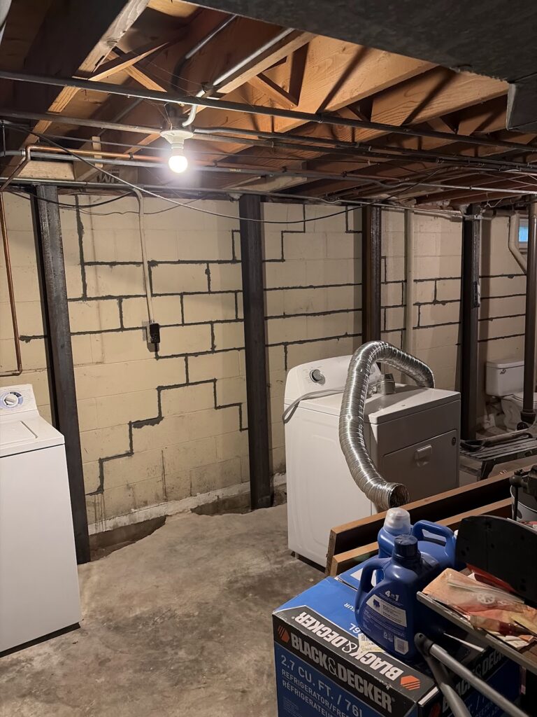 Foundation wall bracing, interior waterproofing and tuckpointing project in Davenport, IA — photo 16 of 19