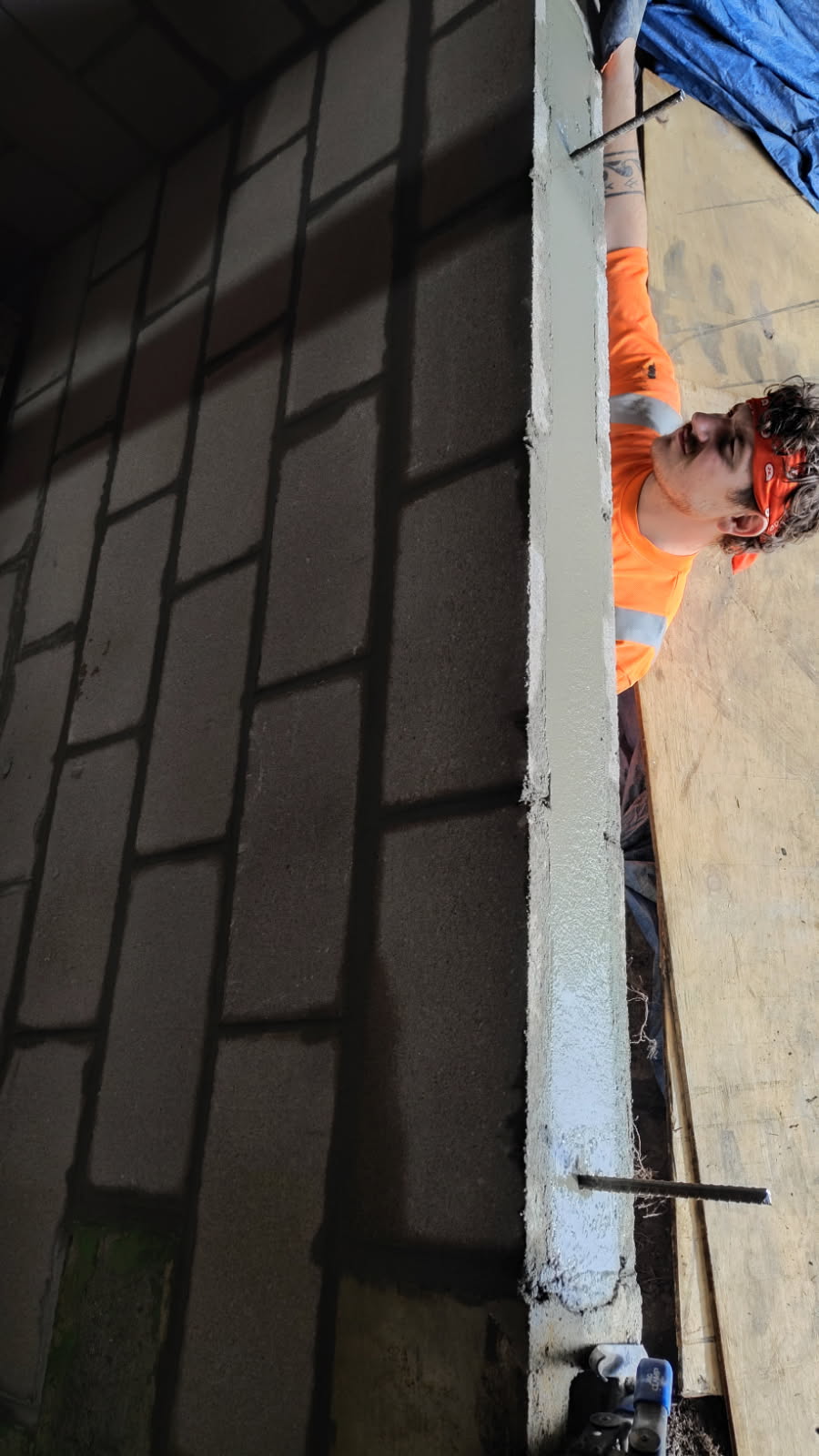 Grouted vertical cell in the rebuilt block wall reinforcing the new masonry