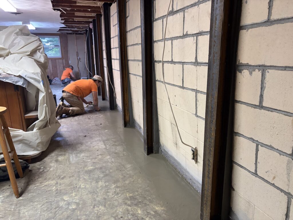 Foundation wall bracing, interior waterproofing and tuckpointing project in Davenport, IA — photo 1 of 19