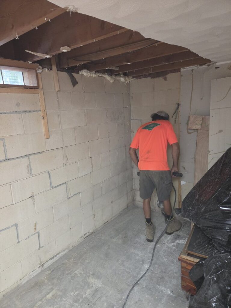 Foundation wall bracing, interior waterproofing, and tuckpointing project