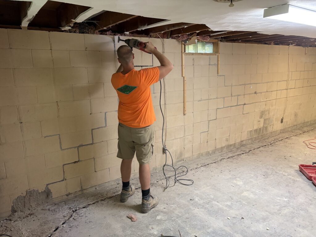 Foundation wall bracing, interior waterproofing and tuckpointing project in Davenport, IA — photo 2 of 19
