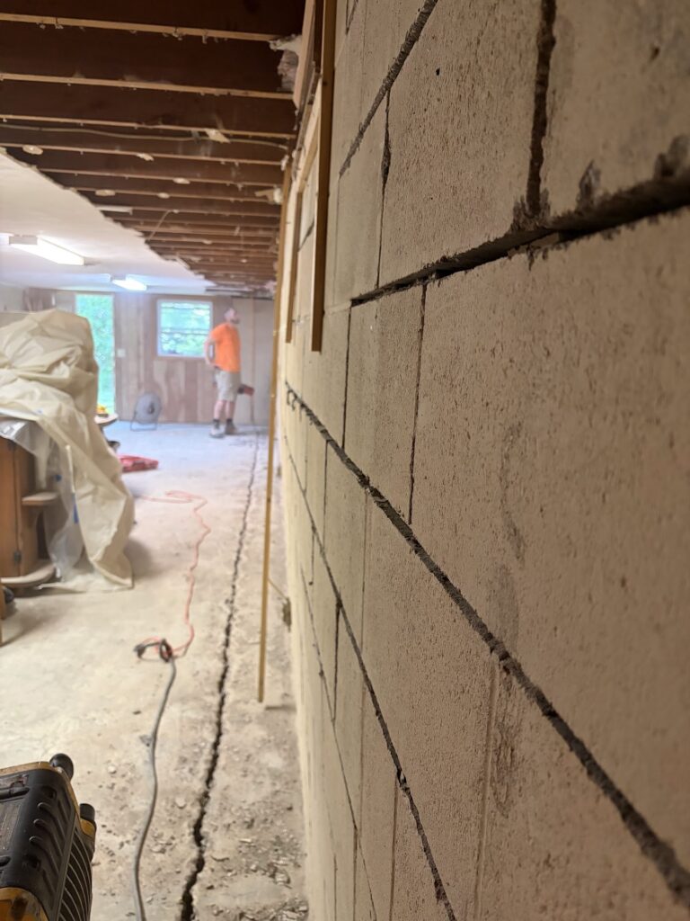 Foundation wall bracing, interior waterproofing and tuckpointing project in Davenport, IA — photo 3 of 19