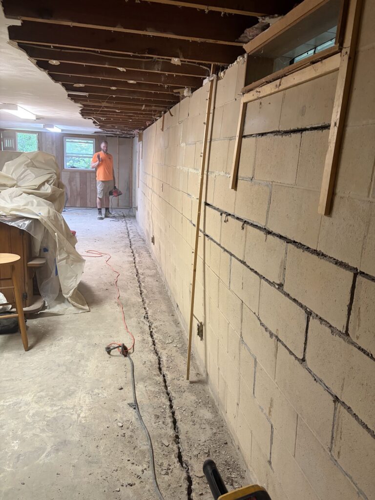 Foundation wall bracing, interior waterproofing and tuckpointing project in Davenport, IA — photo 4 of 19
