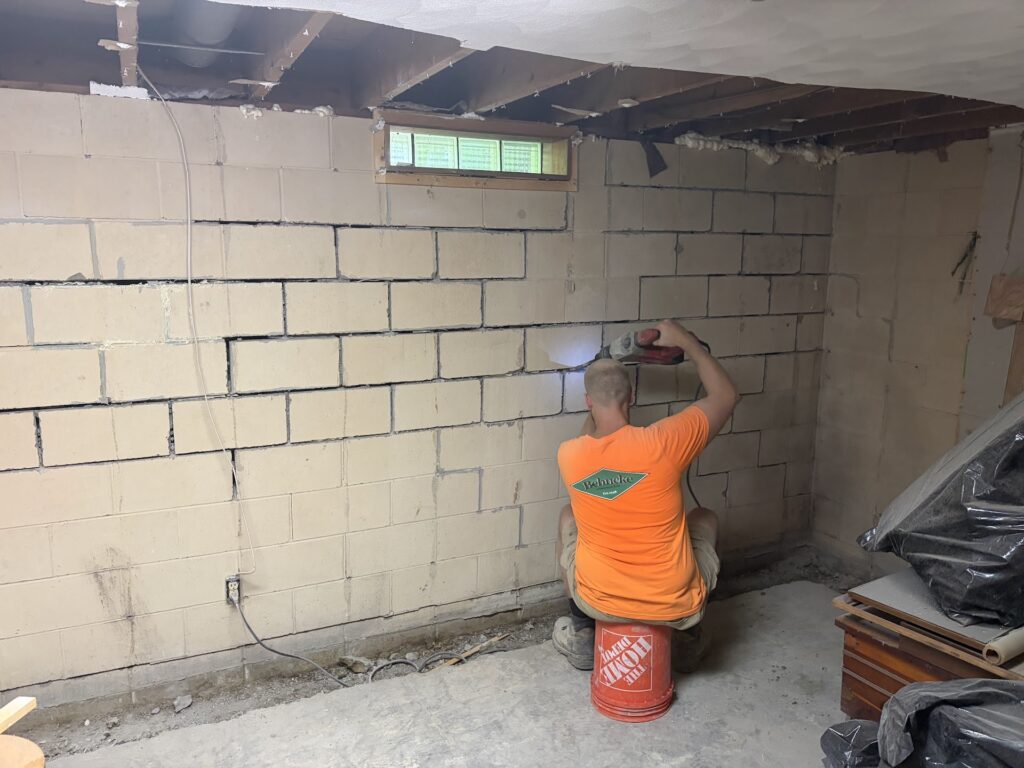 Foundation wall bracing, interior waterproofing and tuckpointing project in Davenport, IA — photo 6 of 19