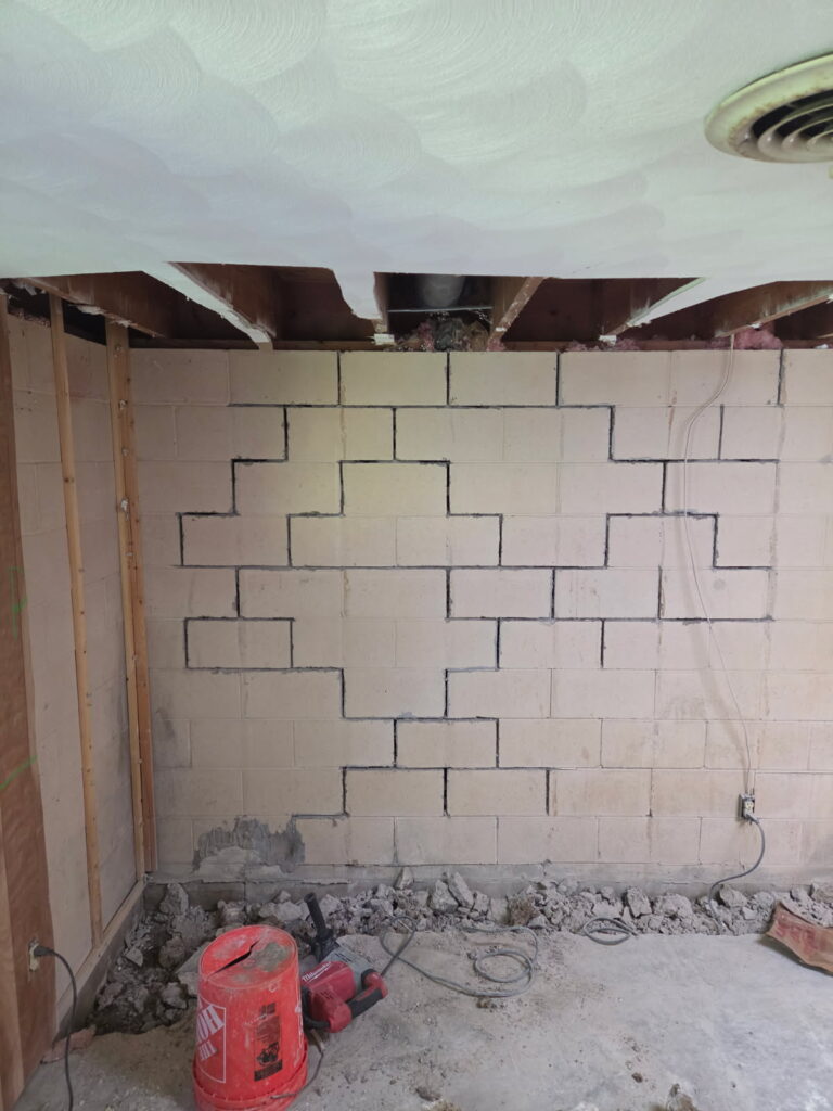 Foundation wall bracing, interior waterproofing and tuckpointing project in Davenport, IA — photo 7 of 19