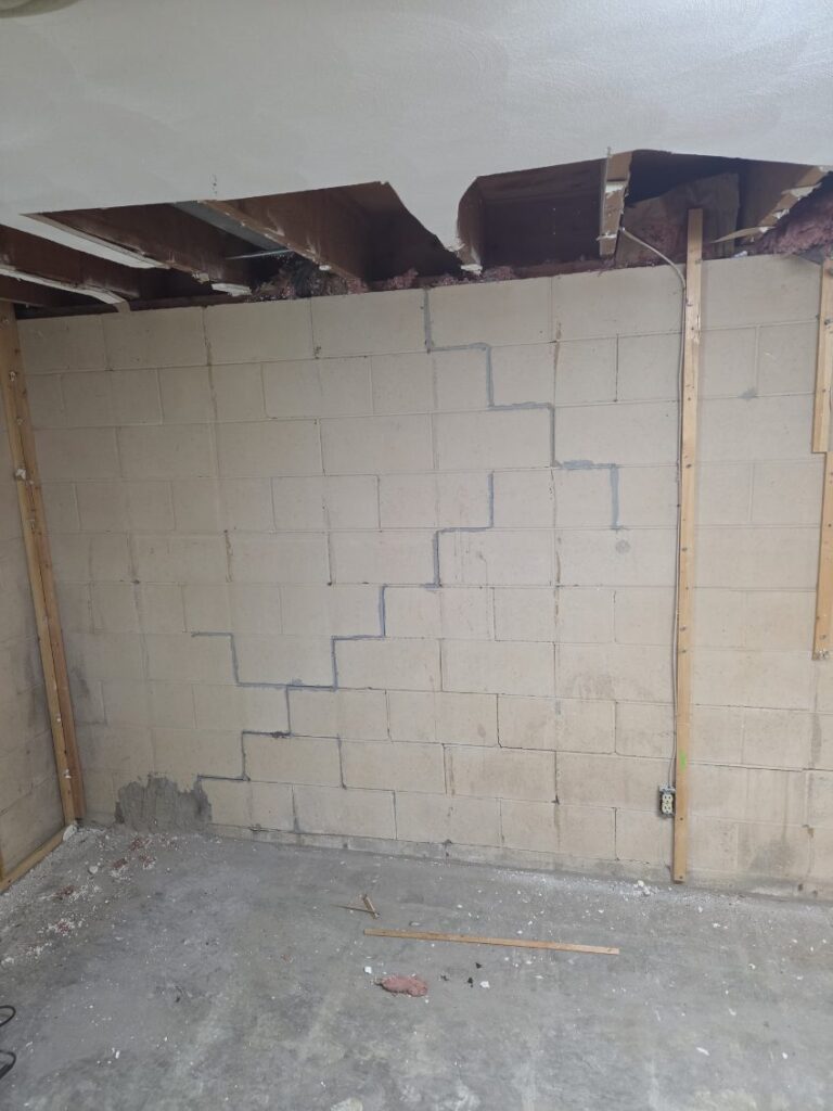 Foundation wall bracing, interior waterproofing and tuckpointing project in Davenport, IA — photo 9 of 19