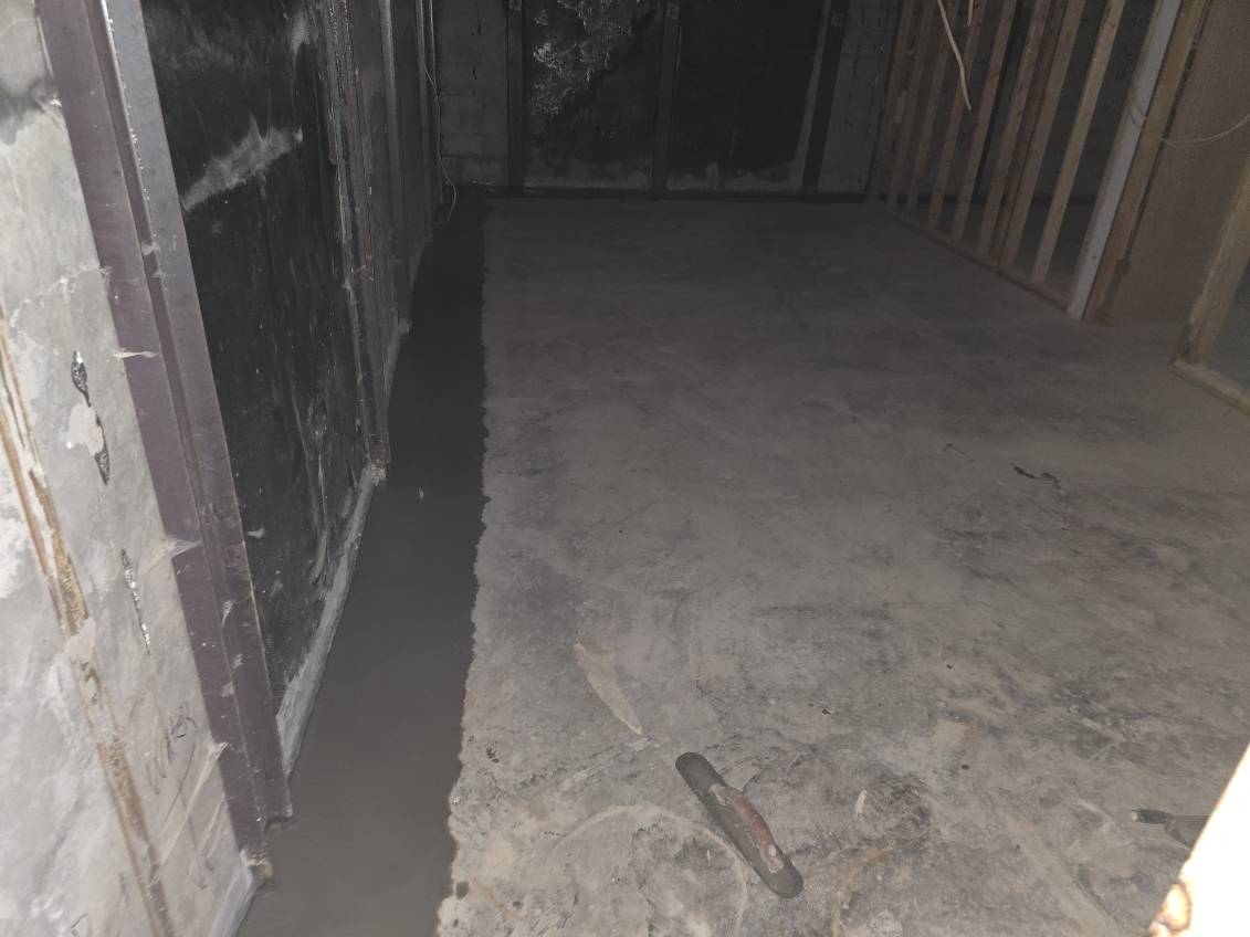Detail of the completed basement waterproofing system in Blue Grass, Iowa