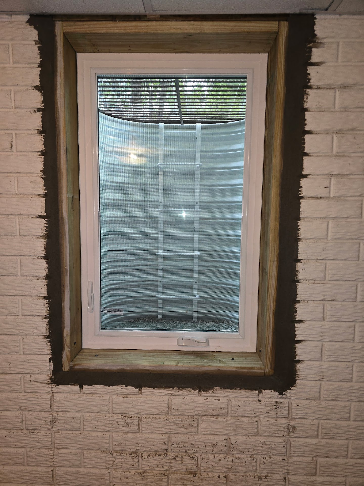 Interior view of the finished code-compliant egress window in the basement