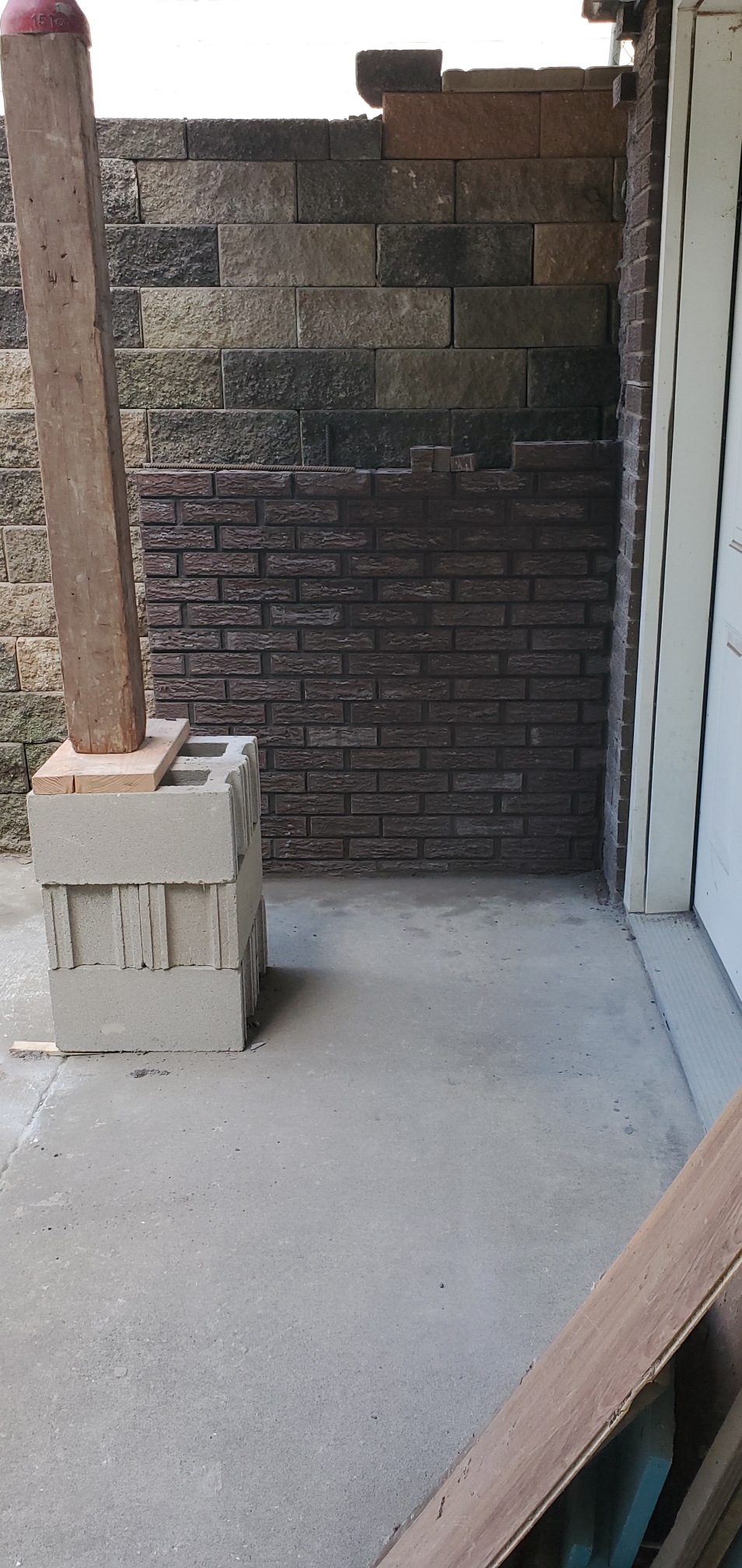 Rebuilt brick wall with the porch post re-supported on a pier