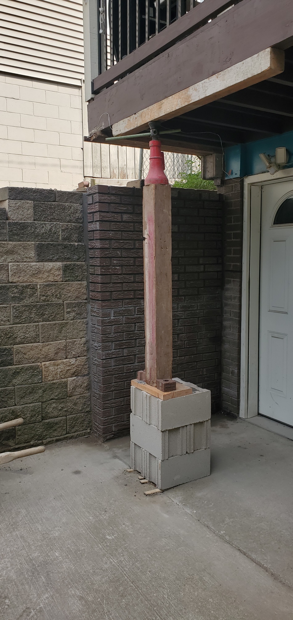 Finished corner where the rebuilt retaining wall meets the porch