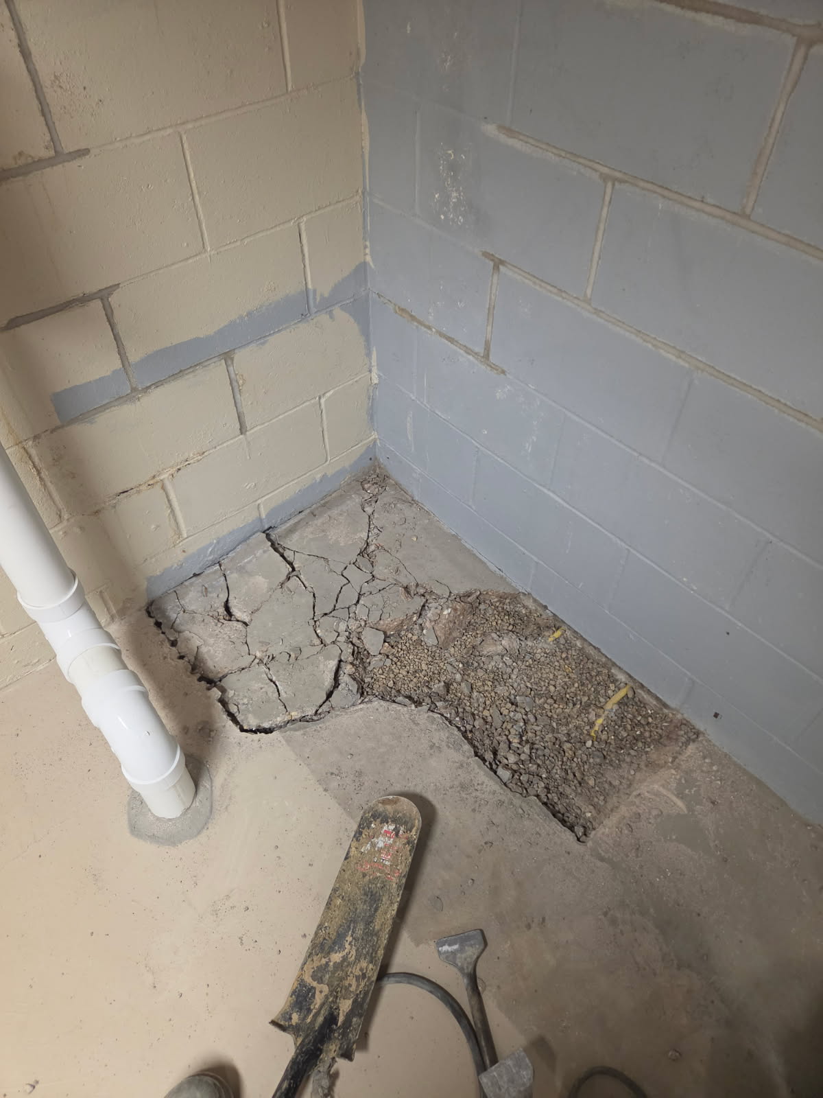 Open trench at the basement wall corner during the drain tile repair