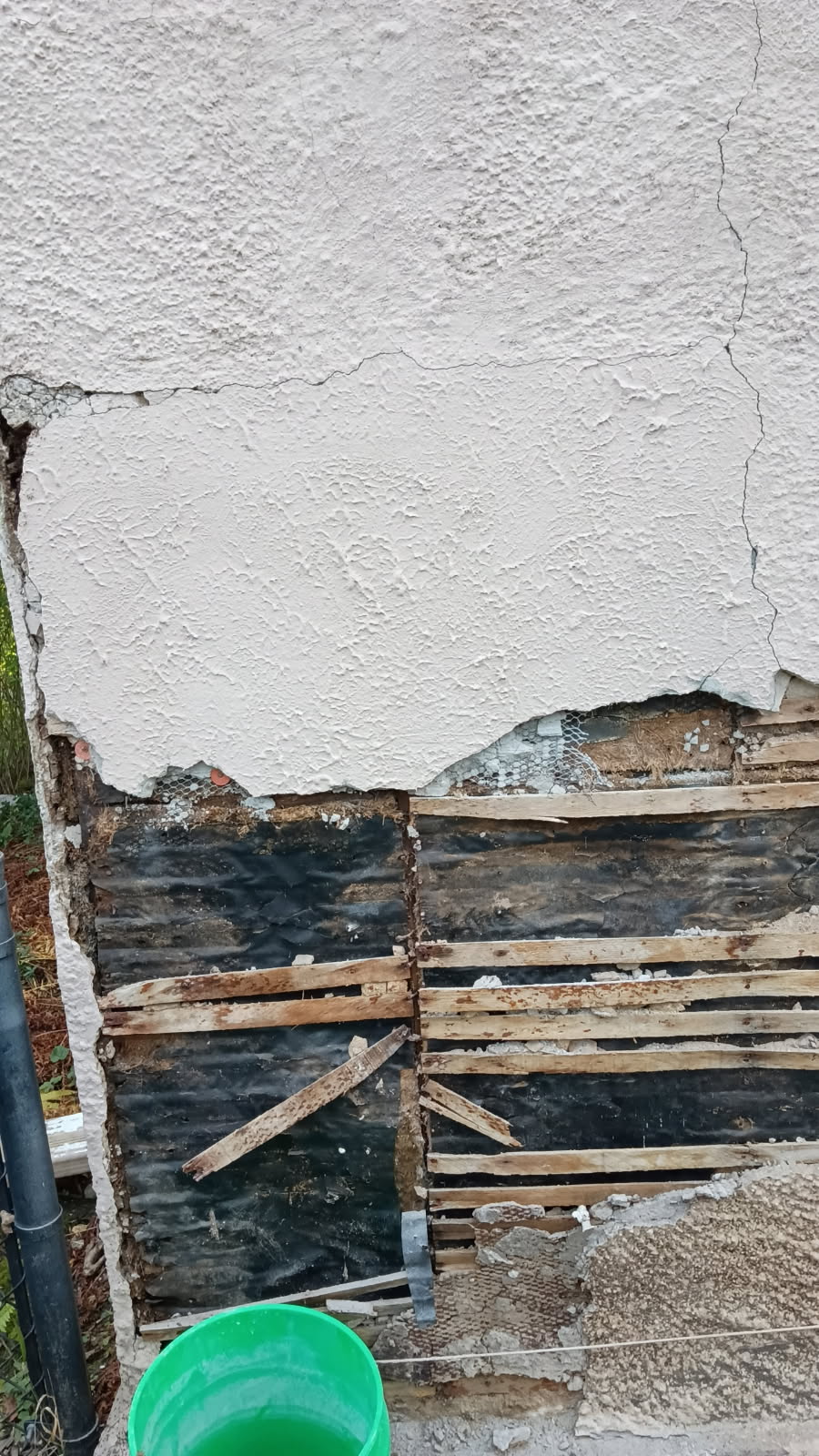 Failing stucco removed showing the framing and sheathing beneath