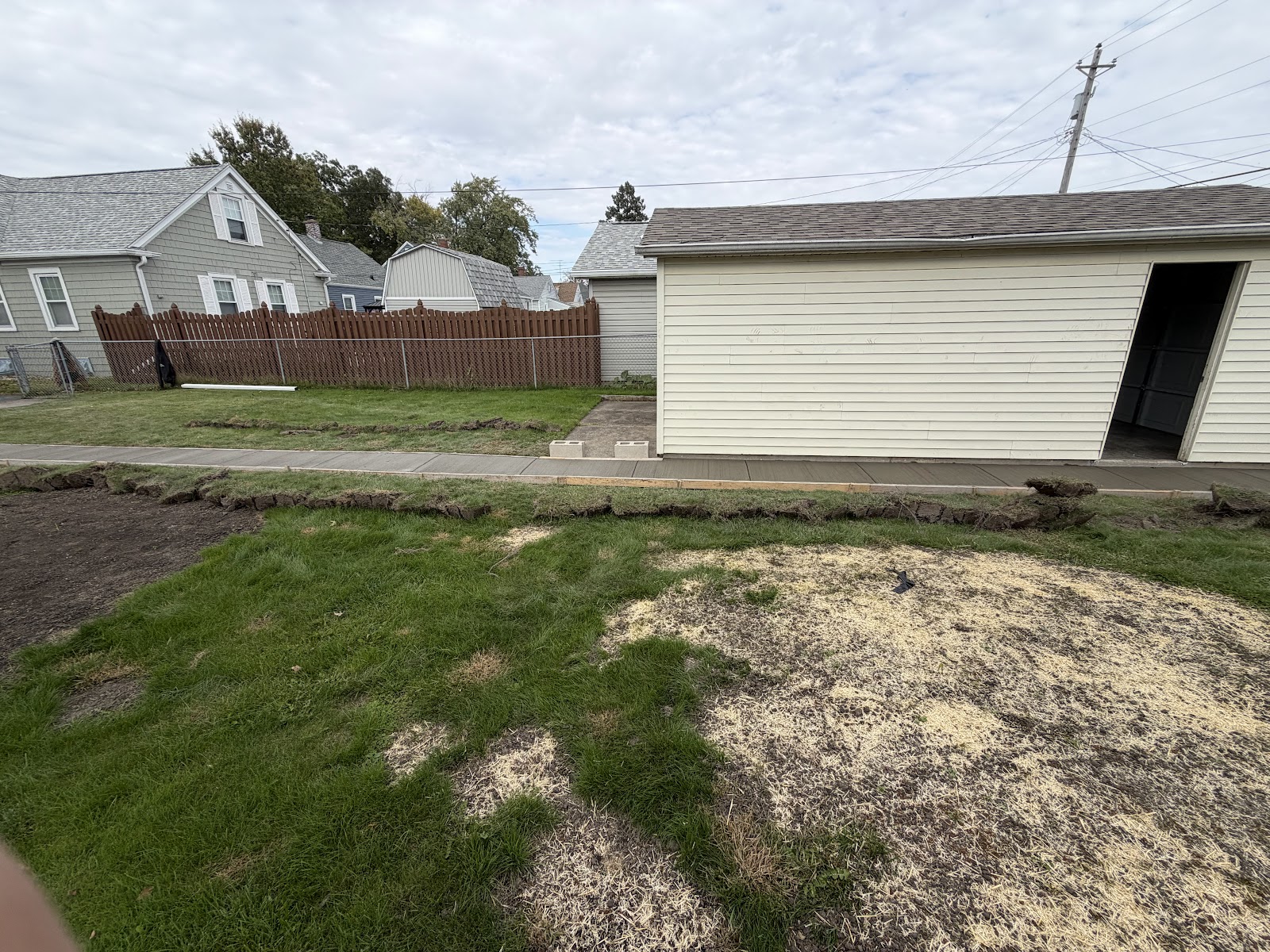 Moline yard restored with seed and straw after foundation and sidewalk work