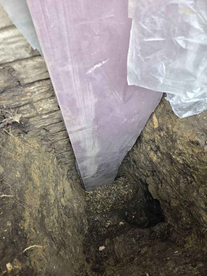 Sheeting placed against the exposed foundation wall in the exterior excavation, Davenport