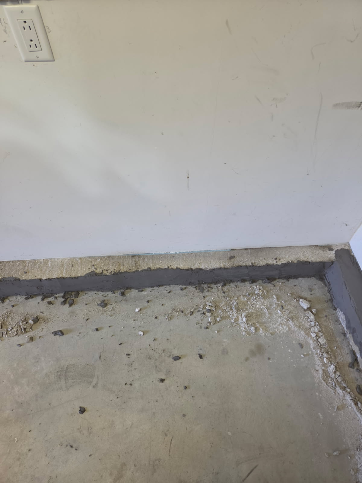 Repaired stem wall along the garage wall after the new material cured